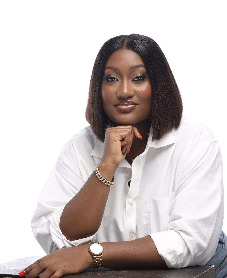 Joanna Bepeh, entrepreneur and women's economic empowerment advocate, seated in a white shirt